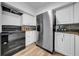 Updated kitchen with stainless steel appliances, granite countertops, and white cabinetry at 8537 93Rd Ave, Seminole, FL 33777
