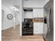 Open concept kitchen featuring white cabinets and stainless steel range and refrigerator at 8537 93Rd Ave, Seminole, FL 33777