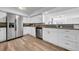 Modern kitchen with white cabinets, stainless steel appliances, and granite countertops at 8537 93Rd Ave, Seminole, FL 33777