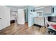 This cute kitchenette features wood-look floors, blue walls and backyard access at 8537 93Rd Ave, Seminole, FL 33777