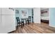 This cozy kitchenette features blue walls, a refrigerator, a table and backyard access at 8537 93Rd Ave, Seminole, FL 33777