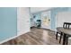 This kitchenette features blue walls, white cabinets, a microwave and backyard access at 8537 93Rd Ave, Seminole, FL 33777