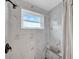 Close up of a bathroom shower featuring sleek marble tile and modern fixtures at 8537 93Rd Ave, Seminole, FL 33777