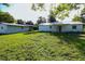 Expansive backyard view of the home with a large, well-maintained green lawn at 8807 Mary Ivy Dr, Plant City, FL 33567
