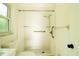 Bathroom featuring a walk-in shower, bright window, grab-bar and toilet at 8807 Mary Ivy Dr, Plant City, FL 33567