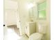 Bathroom featuring a vanity, toilet, bright window and door leading to bedroom at 8807 Mary Ivy Dr, Plant City, FL 33567
