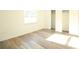 Sunlit bedroom with wood-look flooring and a closet offering ample storage space at 8807 Mary Ivy Dr, Plant City, FL 33567