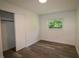 Comfortable bedroom with wood-look flooring, closet, and bright window offering natural light at 8807 Mary Ivy Dr, Plant City, FL 33567