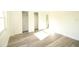 Bright bedroom featuring wood-look flooring, closet and natural light from the large window at 8807 Mary Ivy Dr, Plant City, FL 33567