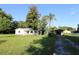An inviting property with a white brick house, screened porch and separate garage and car port at 8807 Mary Ivy Dr, Plant City, FL 33567