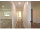 Bright hallway featuring modern floors and neutral paint, connecting living spaces and bedrooms at 8807 Mary Ivy Dr, Plant City, FL 33567