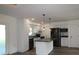 A stylish kitchen featuring an island with pendant lighting and stainless steel appliances for a modern cooking experience at 8807 Mary Ivy Dr, Plant City, FL 33567
