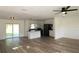Sun-filled living area with updated flooring flowing into a modern kitchen with stainless steel appliances at 8807 Mary Ivy Dr, Plant City, FL 33567