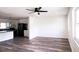 A naturally lit living room features luxury vinyl plank flooring, a ceiling fan, and an open design at 8807 Mary Ivy Dr, Plant City, FL 33567