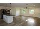 Open living space featuring modern flooring, sleek kitchen island, and recessed lighting for a contemporary feel at 8807 Mary Ivy Dr, Plant City, FL 33567