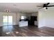 Bright living area with modern flooring flowing into an open kitchen with stainless steel appliances at 8807 Mary Ivy Dr, Plant City, FL 33567