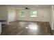 Expansive living area with modern flooring, natural light from large windows, and neutral walls at 8807 Mary Ivy Dr, Plant City, FL 33567