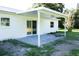 A cozy covered patio offering an outdoor space for relaxation with sliding glass door access to the house at 8807 Mary Ivy Dr, Plant City, FL 33567