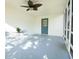Relaxing screened patio with a ceiling fan, table, chairs, and access door to the backyard at 8807 Mary Ivy Dr, Plant City, FL 33567