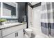 This bathroom features a modern design with dark gray walls and a shower-tub combo at 9028 Forge Breeze Loop, Wesley Chapel, FL 33545