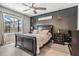 This bedroom boasts a black accent wall and modern ceiling fan for ultimate relaxation at 9028 Forge Breeze Loop, Wesley Chapel, FL 33545