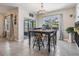 Inviting dining area with a charming black table and a view of the screened-in patio at 9028 Forge Breeze Loop, Wesley Chapel, FL 33545
