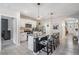 Modern kitchen features granite countertops, sleek white cabinets, and cow print counter seating at 9028 Forge Breeze Loop, Wesley Chapel, FL 33545