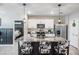 This kitchen features granite countertops, white cabinets, an island, and stainless steel appliances at 9028 Forge Breeze Loop, Wesley Chapel, FL 33545