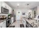 The kitchen showcases stainless appliances, granite countertops, and modern fixtures at 9028 Forge Breeze Loop, Wesley Chapel, FL 33545