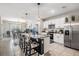 Open kitchen with stainless steel appliances, granite countertops, and an island with barstool seating at 9028 Forge Breeze Loop, Wesley Chapel, FL 33545