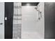 Well-lit shower showcasing a shower curtain and a modern shower head at 9028 Forge Breeze Loop, Wesley Chapel, FL 33545