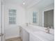 Bright bathroom showcasing a double vanity and a large mirror with ample counter space at 10036 Surrey Rose Dr, San Antonio, FL 33576