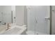 Modern bathroom showcasing an elegant glass-enclosed shower and brushed gold finishes at 10036 Surrey Rose Dr, San Antonio, FL 33576