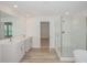 A stunning bathroom features a walk-in shower and double vanity at 10036 Surrey Rose Dr, San Antonio, FL 33576