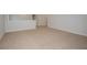 Upstairs bonus room has neutral carpet and a wall-to-ceiling view of natural light at 10036 Surrey Rose Dr, San Antonio, FL 33576