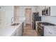 Contemporary kitchen featuring stainless steel appliances, gray cabinets, and quartz countertops on the island at 10036 Surrey Rose Dr, San Antonio, FL 33576