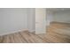 A light-filled room with pristine wood flooring and an open doorway at 10036 Surrey Rose Dr, San Antonio, FL 33576