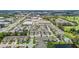 Aerial view of community with townhomes and commercial businesses near a golf course and pond at 1050 Starkey Rd # 704, Largo, FL 33771