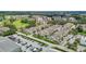 Aerial view of townhomes with well-maintained landscaping, near golf course and water feature at 1050 Starkey Rd # 704, Largo, FL 33771