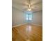 Light filled bedroom with hardwood floors, a modern ceiling fan, and a large window bringing in natural light at 1050 Starkey Rd # 704, Largo, FL 33771