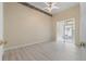 Bright bedroom features laminated wood flooring, decorative ceiling trim, and sliding glass doors to a sunroom at 1050 Starkey Rd # 704, Largo, FL 33771