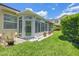 A sunny exterior view of a bright sunroom addition with beautiful green backyard and clear blue skies at 1050 Starkey Rd # 704, Largo, FL 33771