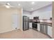 Modern kitchen featuring stainless steel appliances, granite countertops, and sleek white cabinets at 1050 Starkey Rd # 704, Largo, FL 33771