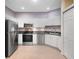 Modern kitchen featuring stainless steel appliances, granite countertops, and sleek white cabinets at 1050 Starkey Rd # 704, Largo, FL 33771