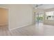 Bright living room featuring sliding glass door, ceiling fan and light wood flooring at 1050 Starkey Rd # 704, Largo, FL 33771