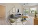 Stylish living room with modern furniture, light wood floors, and a large sliding glass door at 1050 Starkey Rd # 704, Largo, FL 33771