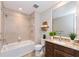Bright bathroom featuring a shower-over-tub, granite-topped vanity, and decorative towel rack at 10520 Boardwalk Loop # 202, Bradenton, FL 34202
