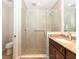 Updated bathroom features a frameless glass shower with tiled walls and floor, granite counter and modern fixtures at 10520 Boardwalk Loop # 202, Bradenton, FL 34202