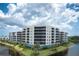 Waterfront condo building featuring balconies and picturesque views, highlighting its desirable location at 10520 Boardwalk Loop # 202, Bradenton, FL 34202