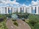 Grand entrance to waterfront condos with lush landscaping and brick-paved drive, setting a welcoming tone at 10520 Boardwalk Loop # 202, Bradenton, FL 34202